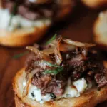 Braised Beef Crostini with Blue Cheese Butter and Caramelized Onions